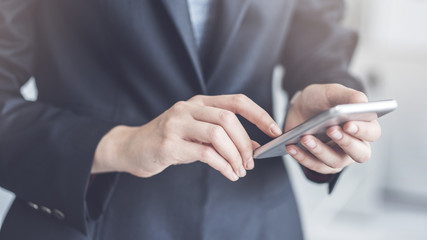 Businesswoman using mobile phone in office