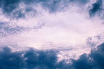 Naklejka na ściany i meble Background of gray dramatic clouds in the dark sky before a thunder.