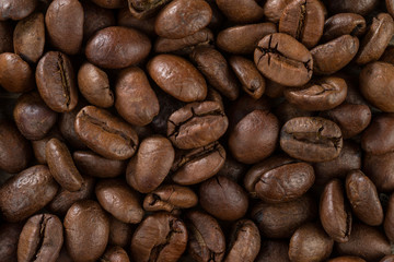 Texture of surface of roasted coffee beans. A bunch of coffee beans arabica.