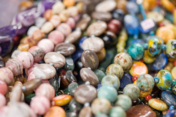 Macro shot of rhodochrosite stone, jasper, glass, hrizokola stones. Gemstone bracelets and...