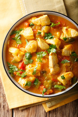 Brazilian traditional Bobo chicken with vegetables in coconut milk close-up. Vertical top view