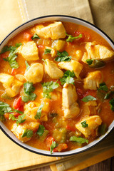 South American Food: Bobo chicken stew with vegetables in coconut milk close-up. Vertical top view