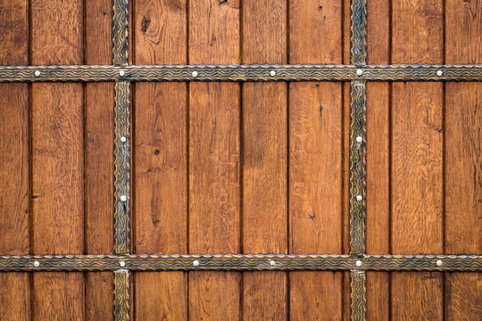 wooden gate with wrought iron elements close up