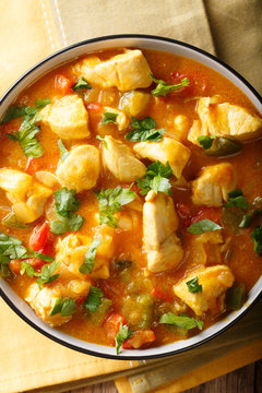 South American Food: Bobo chicken stew with vegetables in coconut milk close-up. Vertical top view