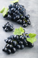 Blue grapes on grey wooden table
