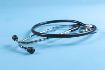 Stethoscope on blue wooden background