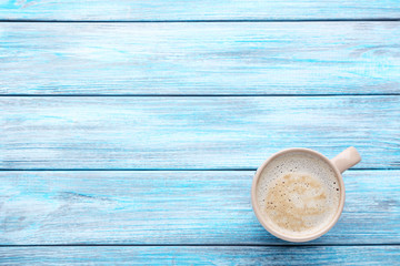 Cup of coffee on blue wooden table