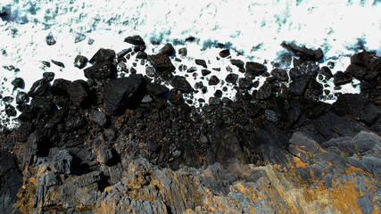 Aerial view of sea waves crash on the shoreline. Portuguese coastline