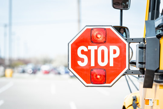 School bus stop sign with flashing lights