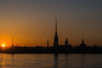 Golden sunset on the Neva embankment overlooking the Peter and Paul fortress.
