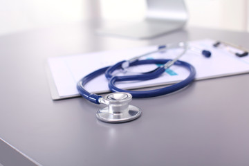 Medical equipment: blue stethoscope and tablet on white background. Medical equipment