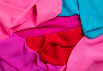 bright draped background of multi-colored chiffon fabric