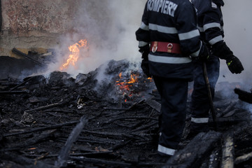 Firefighters using water hoses to extinguish a fire