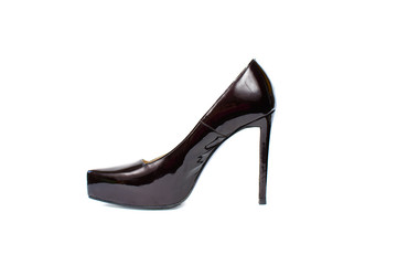 Lacquered black sexy shoe with high heel isolated on white. Women classic varnished shoe close up. One fashionable elegant luxury footwear item.