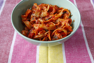 pasta tagliatelle with tomato sauce in a bowl on table cloth