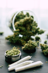 weed Joint Macro of cannabis buds marijuana with trichomes and crushed weed on a black table insta close up