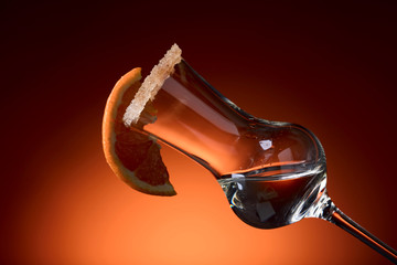 Glass of tequila with orange, garnished with sugar and cinnamon powder.