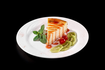 piece of Cheesecake on a plate, black background
