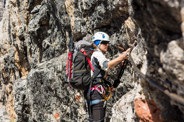 Female climber on via ferrata route.