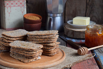 Healthy food concept. Breakfast with crispbreads, butter, jam. Flatbread crackers with sesame, flax seed, pumpkin and sunflower seeds. Diet crispy cookies. Snack gluten-free. Copy space
