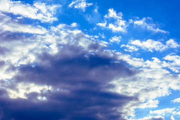 A charming blue sky with amazing fabulous clouds floating around it