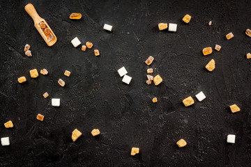 Ingredients for sweets and desserts background. Sugar on black table top view