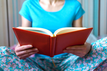 A girl is reading a book.