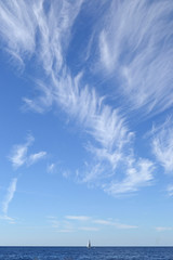 Tuscany, blue sky and white striped clouds on the Tyrrhenian Sea