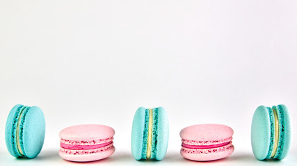 multicolored macaroons on a light background