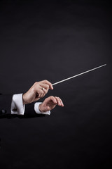 Conductor conducting an orchestra isolated on black background © Алексей Куренев