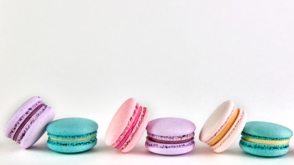 multicolored macaroons on a light background