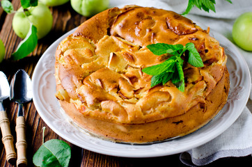Apple cake on the plate on a wooden table