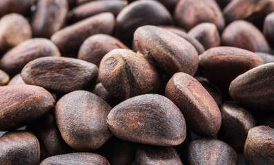 Unshelled pine nuts. Macro. Food background.