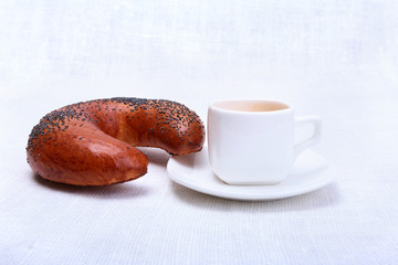 Coffee cup and fresh baked croissants on white background. Top View.