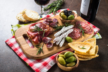 Antipasto delicatessen - sliced meat, ham, salami, olives on woo