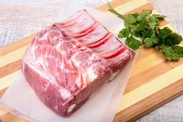 Raw pork chops, spices and basil on cutting board. Ready for cooking.