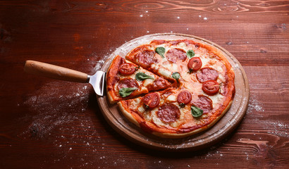 classic Italian pizza on a wooden tray, served in a small authentic Italian restaurant