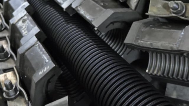 Manufacture of plastic water pipes. Manufacturing of tubes to the factory. The process of making plastic pipes on the machine tool with the use of water and air pressure. Special corrugated forms of