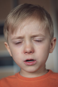 Five Years Old Boy With Allergy Runny Nose And Closed Eyes.