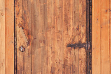 wooden door with iron hinges.