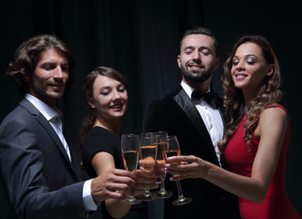 Cheerful people celebrating a sucess with Champagne