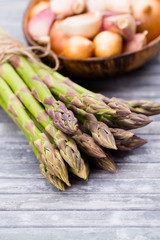 Bunch of fresh asparagus on wooden table.