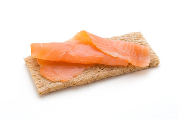 Bread with fresh salmon fillet isolated on white background, top view.