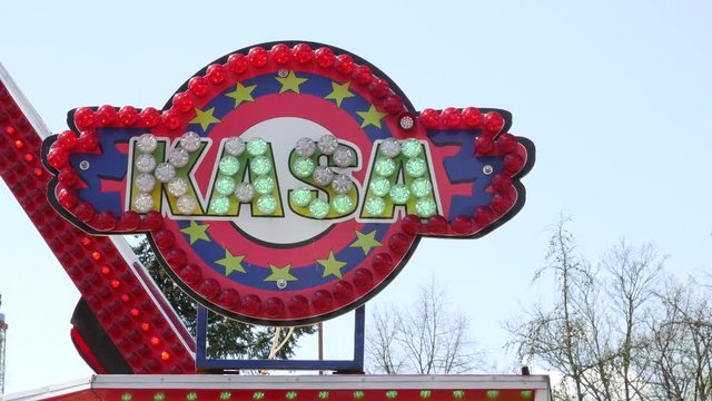 Flashing neon lights and light bulbs in the amusement park. Cash register and ticket sales.