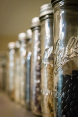 Row of canning jars displaying beans and dry goods
