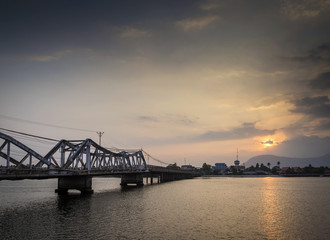 Fototapeta na wymiar bridge and river at sunset in kampot cambodia