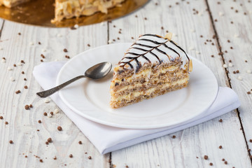 Dark chocolate vegan cake with candies and nuts on wooden background