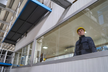 Engineer worker at control room. Portrait of a young technician worker in a factory. The operator...