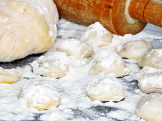 Cooking dumplings. Raw dumplings, dough, flour.