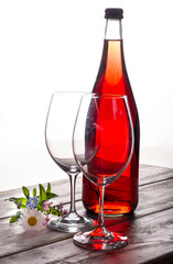 Rose wine served with two glasses and flowers copy space close up